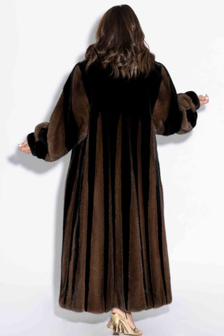 back of woman wearing a ranch and demi buff two-toned full length mink fur coat against white backdrop