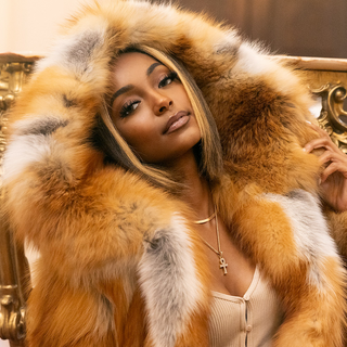 lady wearing a natural red fox fur with hood