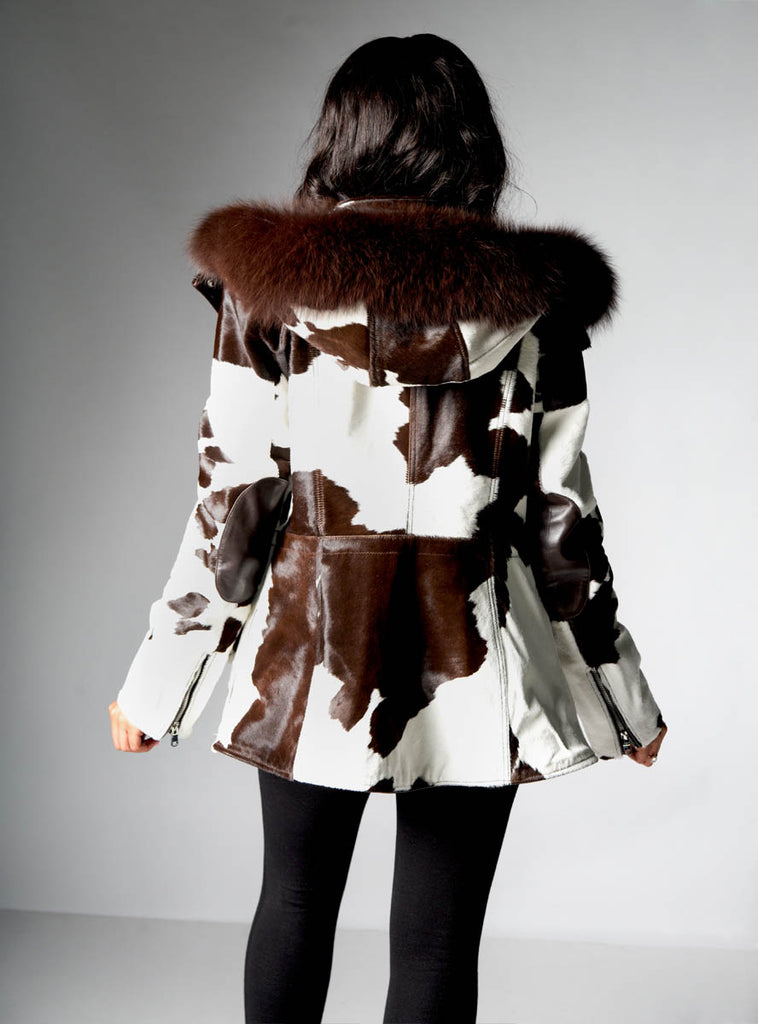 brown & white cowhide leather jacket with raccoon fur trimmed hood