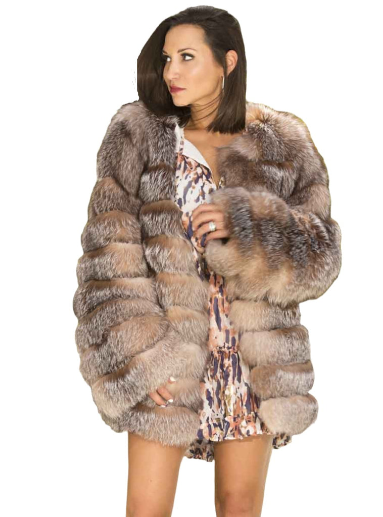 woman wearing a horizontal pattern crystal fox fur jacket outside with trees surrounding - Shop our Women's Furs!