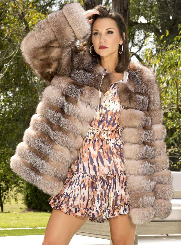 woman wearing horizontal pattern crystal fox jacket outside with trees surrounding - Shop our Women's Furs!